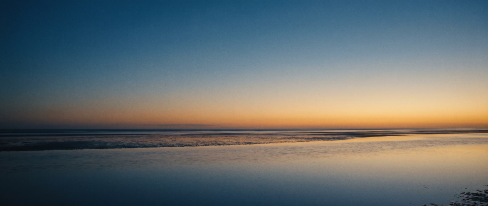 First light breaking over a wide empty horizon